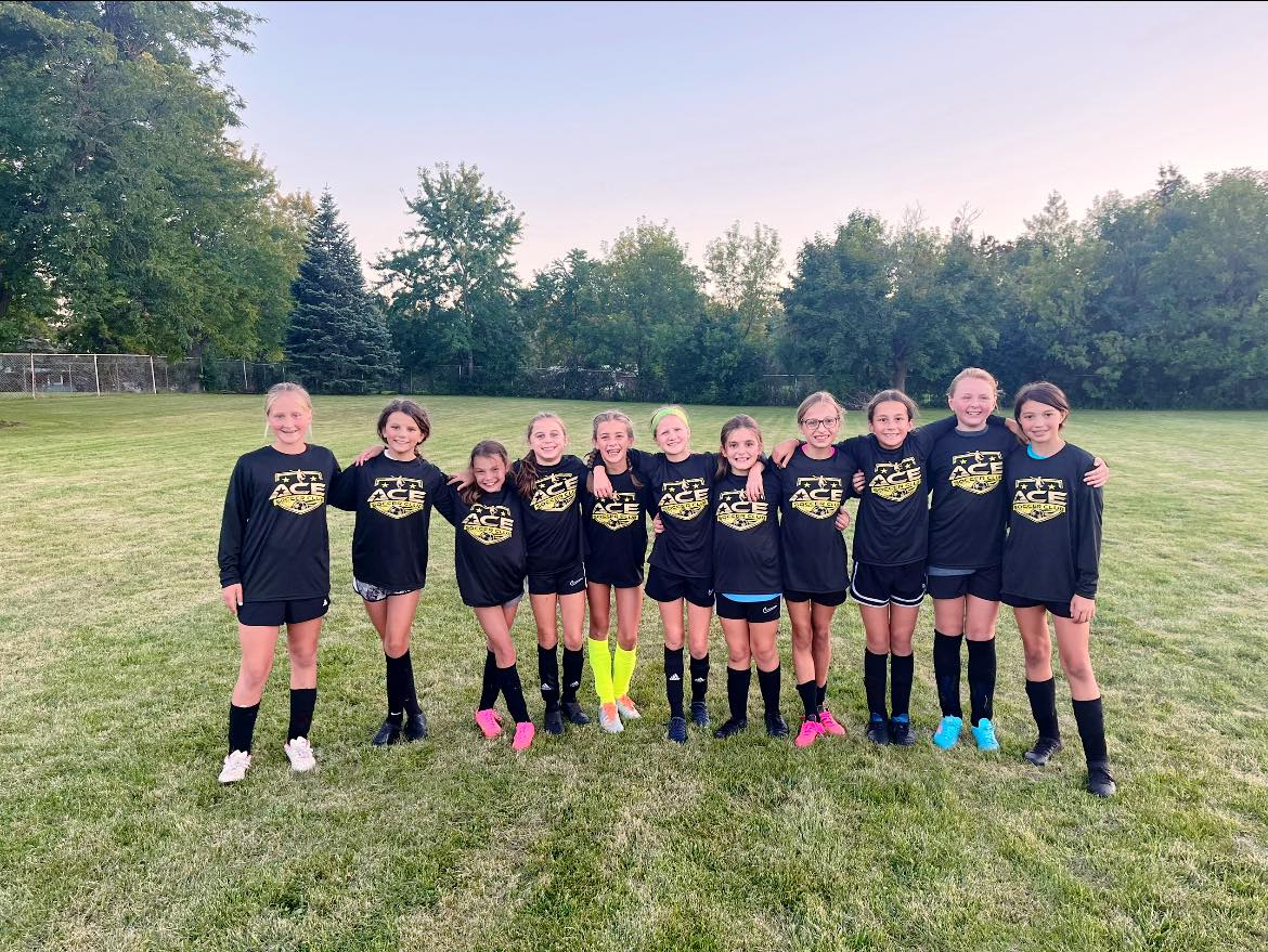 ACE Girls team arm-in-arm at sunset training at Franksville Park