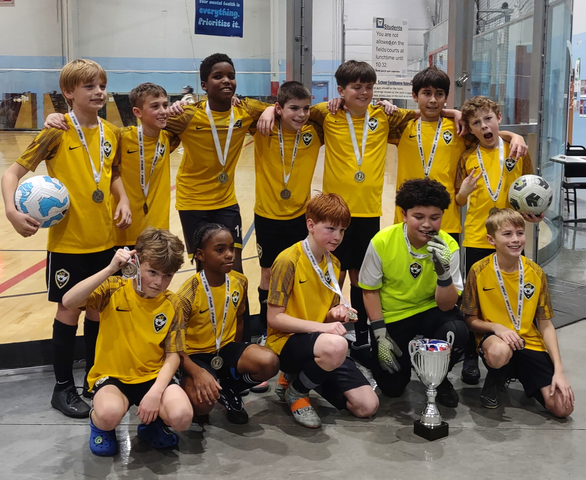 ACE Boys team with medals and championship trophy at indoor finals